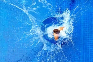 man jumping in the pool